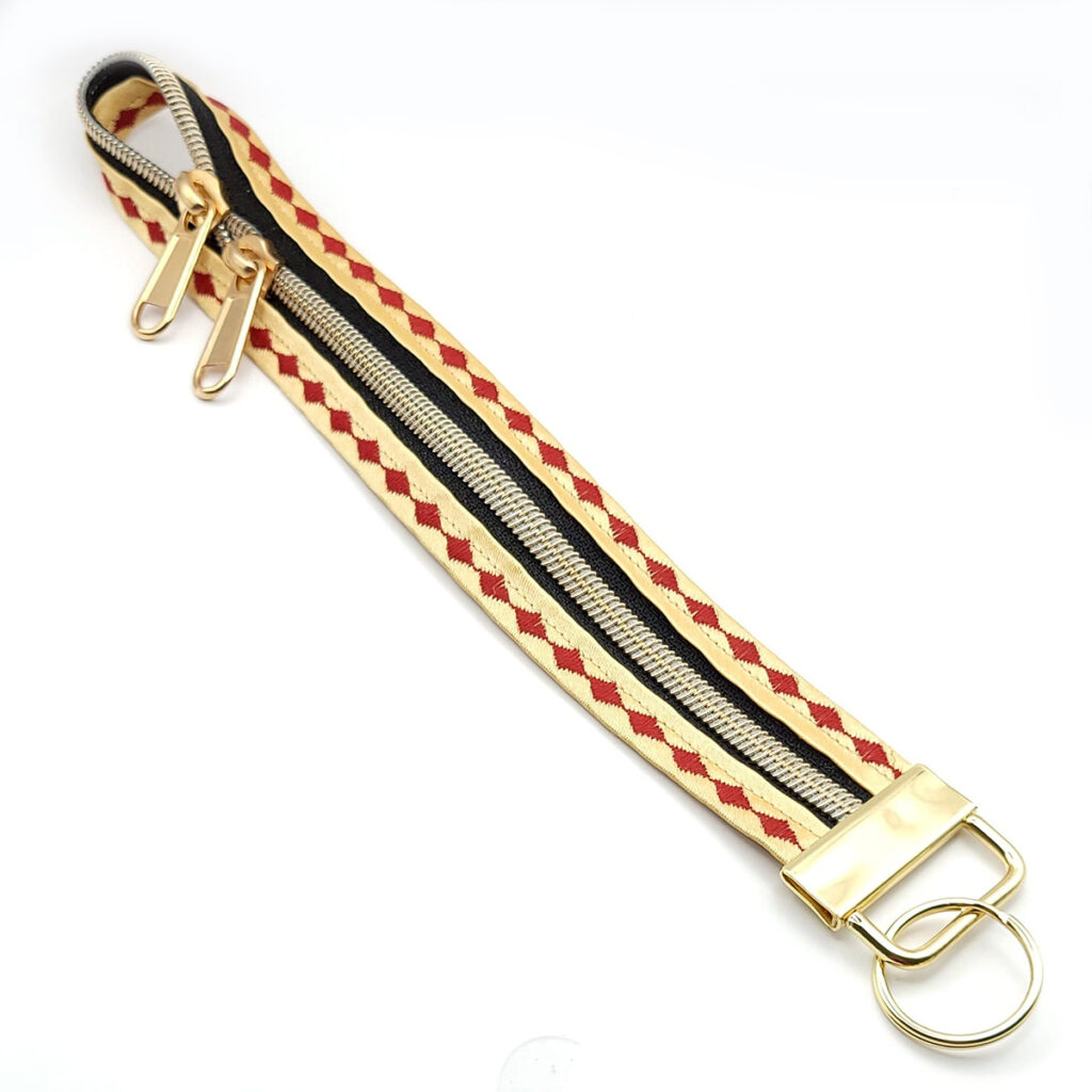 Reißverschluss-Schlüsselband M in gold-rot